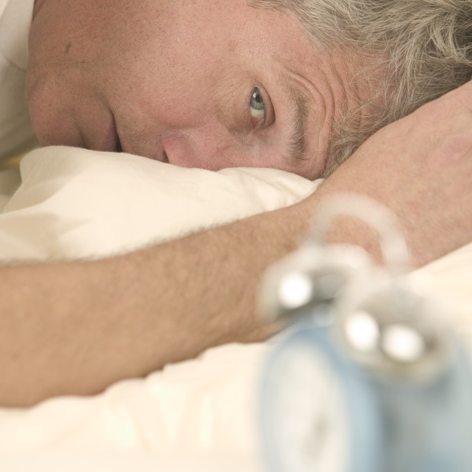 Man Waking to Alarm Clock